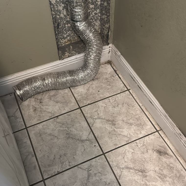 Clean floor and neatly reconnected dryer duct after service