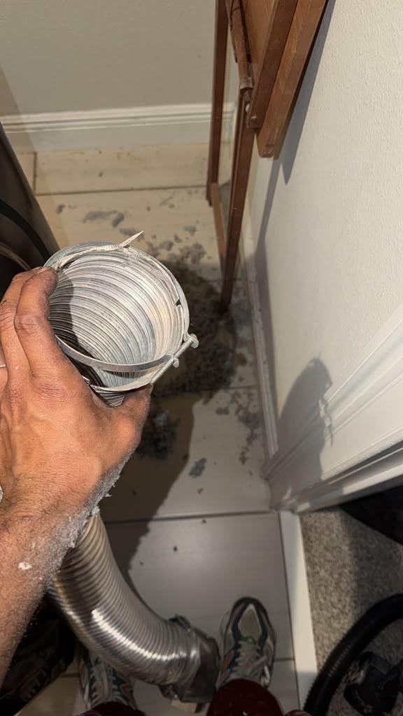 Dryer duct being cleaned
