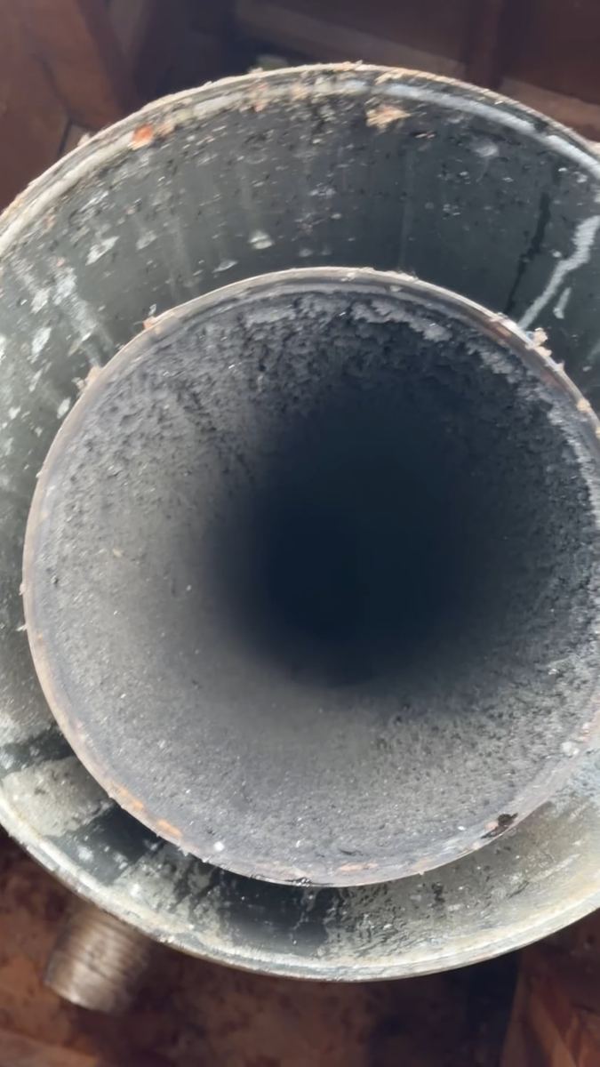 Chimney flue caked with creosote before cleaning