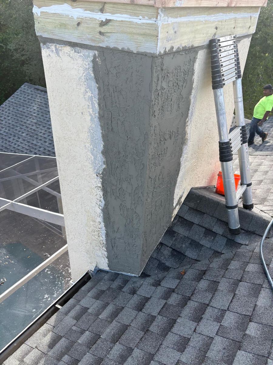 Freshly stuccoed chimney on the roof